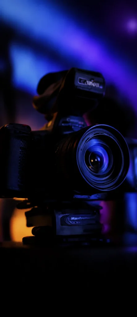 Cinema camera on set, lit in blue and purple